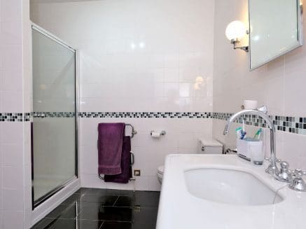 image of bathroom showing shower and traditional basin
