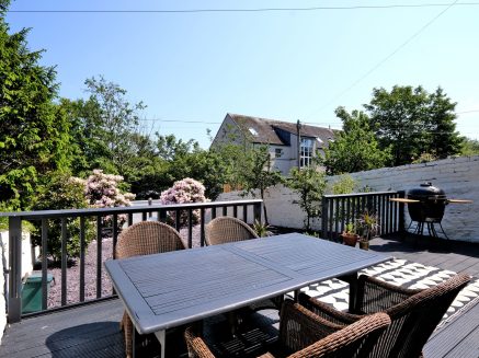 image of a tble on a terrace in a residnetial garden denoting outdooe entertaining space