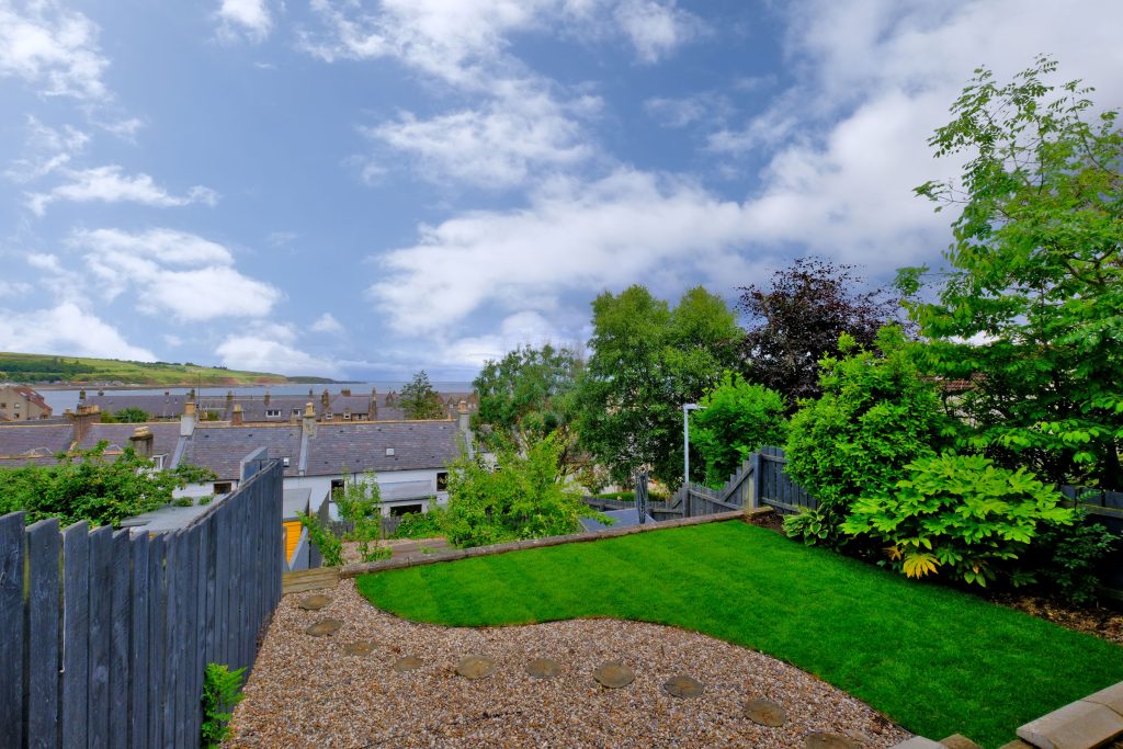 back garden with grass patch and views of surrounding properties 