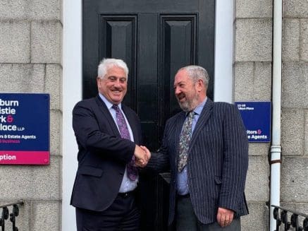image of Callum McDonald Managing Partner RCCW and Alistair Marshall Consultant outside RCCW HQ upon the announcement of RCCW's merger with Mackie & Dewar